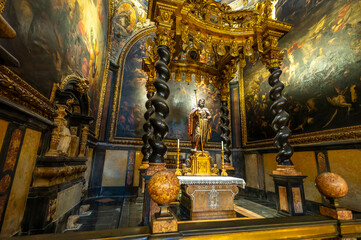 Baroque baldachin with black marble solomonic columns inside the Chapel of San Pedro Arbues at the Cathedral of La Seo, ornate interior architecture in Zaragoza. © javier