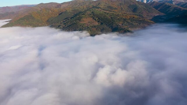 Aerial view of autumn morning fog and clouds in the valley