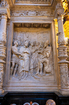 Vertical view of a finely carved plaster/stone high-relief panel depicting Saint Valerius (San Valero) and Saint Vincent standing before the Roman judge Dacian, framed by ornate plateresque columns on