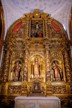 Vertical view of the gilded baroque altarpiece inside the Chapel of Saint Valerius featuring San Valero and side paintings at La Seo Cathedral in Zaragoza.