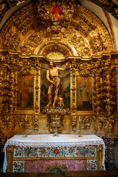 Frontal view of the ornate gilded baroque altarpiece featuring Saint John the Baptist inside a chapel at La Seo Cathedral in Zaragoza.