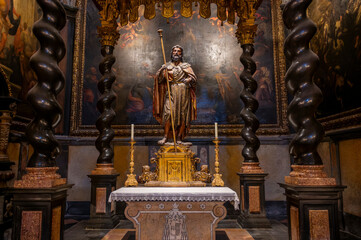 Baroque baldachin with black marble solomonic columns inside the Chapel of San Pedro Arbues at the Cathedral of La Seo, ornate interior architecture in Zaragoza. © javier