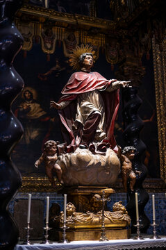 Baroque statue of Saint Peter Arbues on a cloud with cherubs inside the Chapel of San Pedro Arbues at the Cathedral of La Seo, dramatic sacred art sculpture in Zaragoza.
