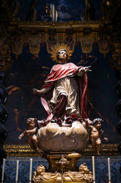 Baroque statue of Saint Peter Arbues on a cloud with cherubs inside the Chapel of San Pedro Arbues at the Cathedral of La Seo, dramatic sacred art sculpture in Zaragoza.