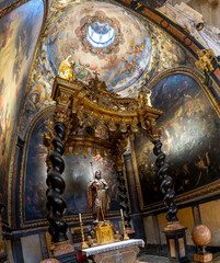 Baroque baldachin with black marble solomonic columns inside the Chapel of San Pedro Arbues at the Cathedral of La Seo, ornate interior architecture in Zaragoza. © javier