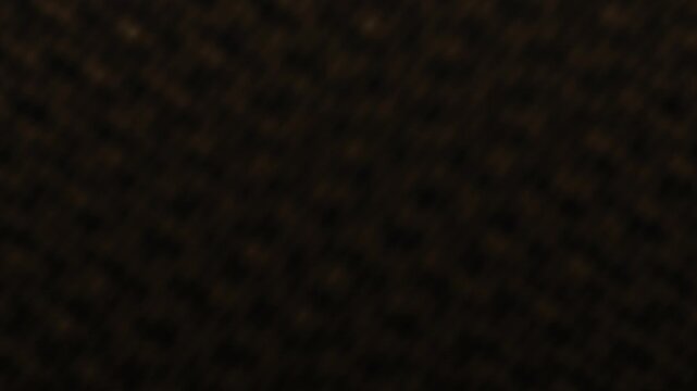Abstract dark brown texture background with subtle granular pattern.