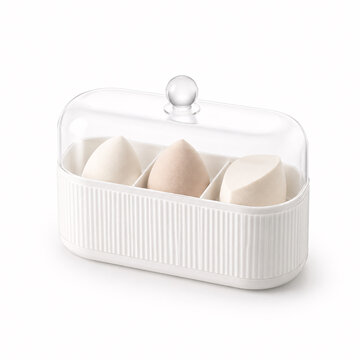 Four makeup sponges in a white storage box