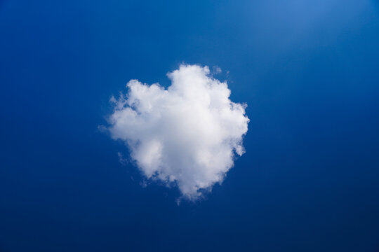 Heart Shaped Cloud Under a Bright Blue Summer Sky with Fluffy White Clouds and Peaceful Nature Scenery
