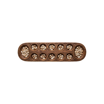 Traditional wooden congklak board game with shells isolated on white background