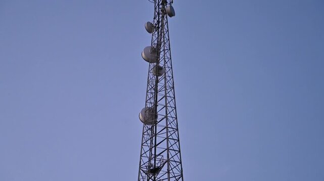 Telecommunication Tower Against Clear Blue Sky, Cellular Network Infrastructure and Wireless Communication Technology, 4K Footage