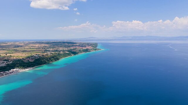 Aerial view of turquoise sea coastline and farmland