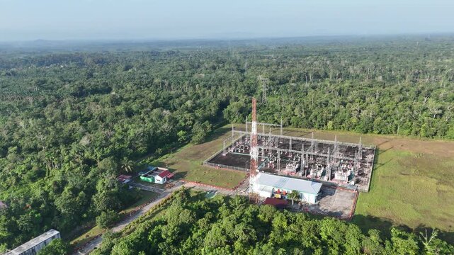 Aerial view of an electrical substation located in the middle of a tropical rainforest.