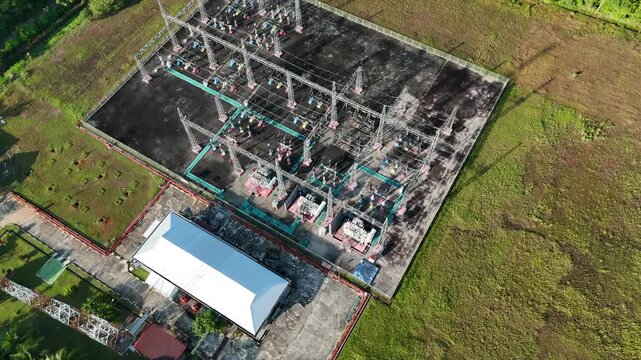 Aerial view of an electrical power substation facility in a rural landscape.