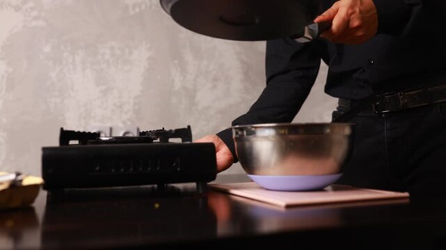 Making pancakes in the kitchen using a bowl and a frying pan for a simple breakfast task each morning