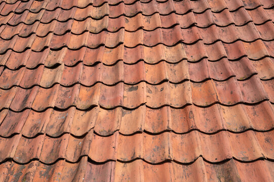 Old terracotta roof tiles forming weathered pattern