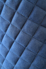 Obraz premium Blue quilted chair fabric texture