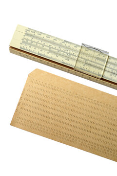 Vintage mechanical slide rule and computer punched card on white background