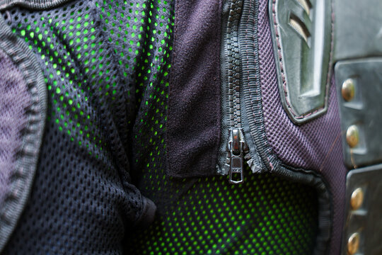 Green mesh motorcycle jacket with protective armor and metal zipper detail creating rugged urban riding vibe