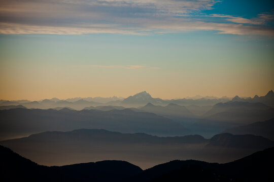 Layers of hazy mountains fade into the twilight sky