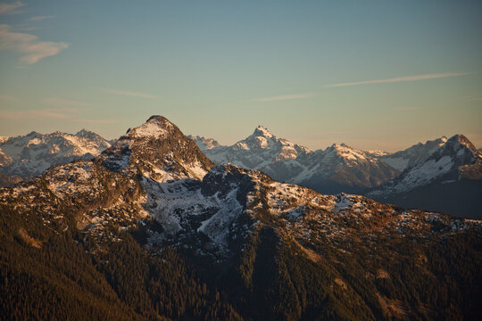 Snow capped mountain range during golden hour