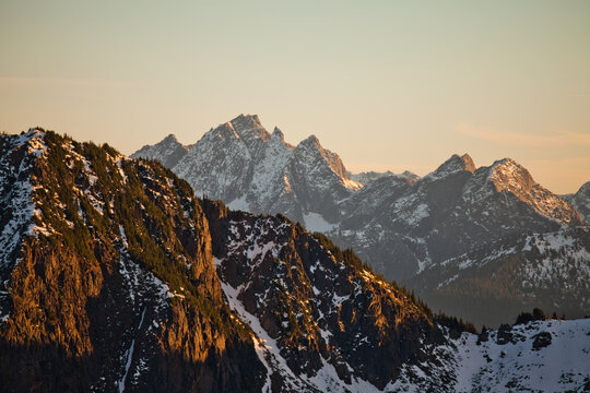 Golden light hits snowy peaks, Mount Rexford, at sunset