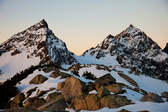 Rugged snow covered mountains, Foley and Welch, at golden hour