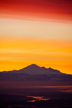 Mount Baker silhouetted against a fiery sunrise