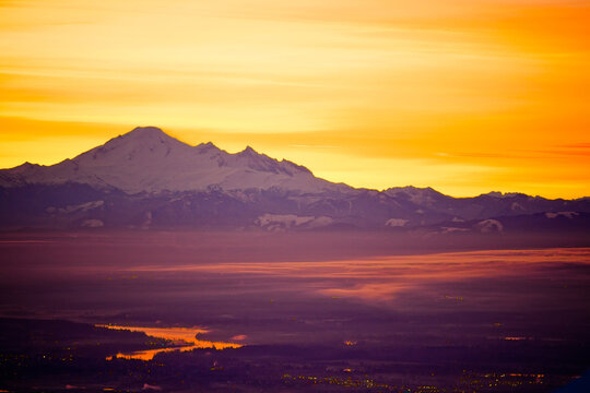 Mount Baker silhouetted against a fiery sunrise