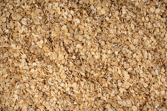 Oat flakes textured pattern, rolled oatmeal macro background