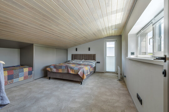 Spacious Bedroom Interior with Double Bed, Niche Bed, and Windows