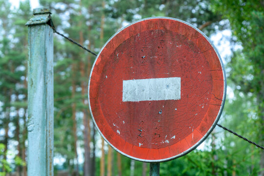 Vintage No Entry Traffic Sign with Barbed Wire in Forest