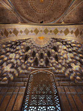 Ornate interior ceiling and muqarnas of Gur-e-Amir mausoleum in Samarkand Uzbekistan. Gilded geometric patterns and tilework showcase Timurid architectural mastery, ideal for travel and heritage.