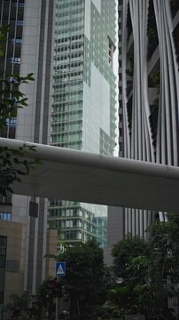 Urban skyline of Singapore with modern office skyscrapers surrounding a multilevel open garden in the financial district representing innovation and business success in Asia