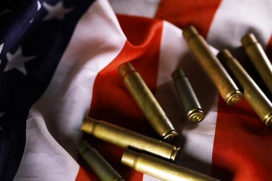 Many bullets cartridges and medals on United States flag. Concept of war glory victory. Gun trafficking on special operations