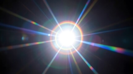 Obraz premium Bright sunburst with rainbow lens flare spreading rays across a clear sky.