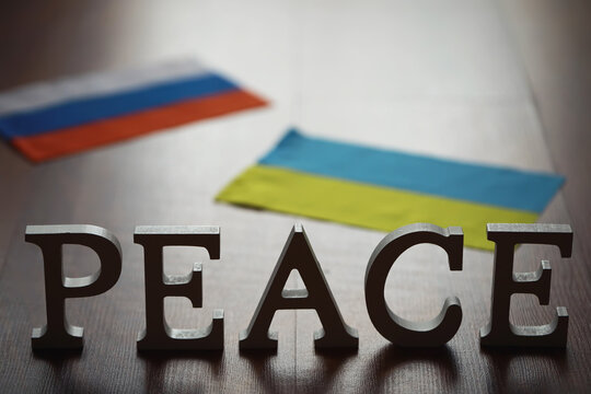 Peace Word Written In Wooden Letters. International conflict, American hegemony, War. Ukraine and Russia.