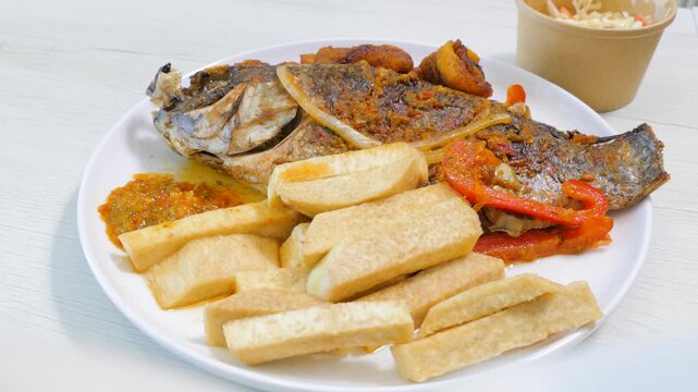West African fried tilapia fish with fried yam wedges