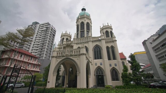 Elegant architecture of Saint Joseph Church rising among Singapore skyscrapers with Catholic heritage modern city skyline and multicultural travel destination in Asia