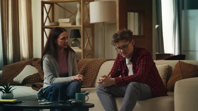 Displeased mother reprimanding her teenage son for bad behavior, family conflict