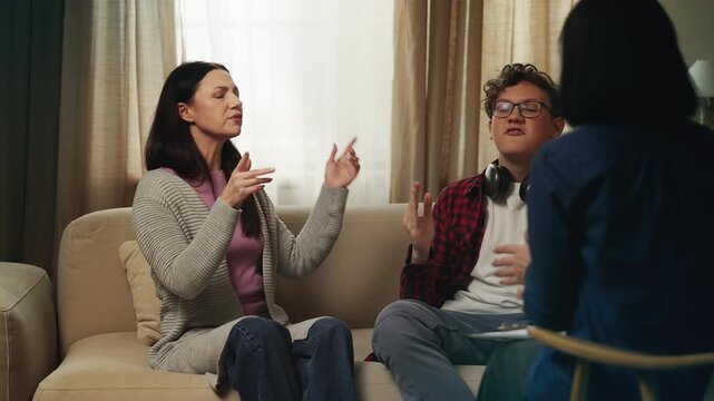 Teenage boy complaining about his mom to a psychologist during family therapy
