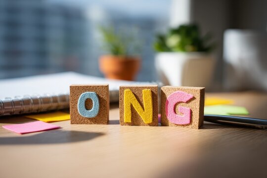 Colorful sticky notes spelling ONG on a corkboard in a modern workspace