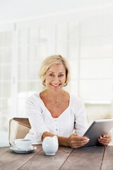 Smile, woman and relax at house with tablet, social media and browsing for weekend break. Portrait, mature person and coffee in home with digital, download ebook and reading news for morning routine