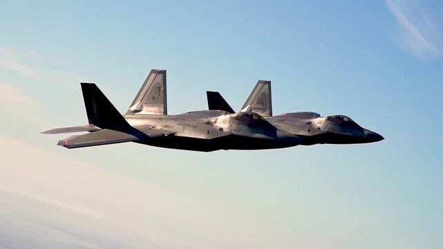 Two Stealth Fighter Jets Flying in Tight Formation During Advanced Tactical Air Dominance Training Mission.