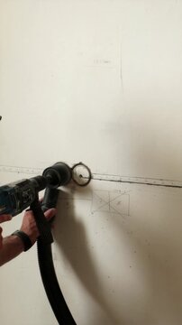 Close up of diamond core bit drilling wall socket vertical