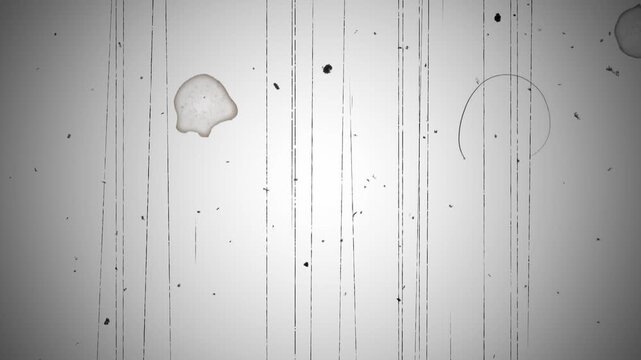 Vintage film with heavy vertical scratches with reflections