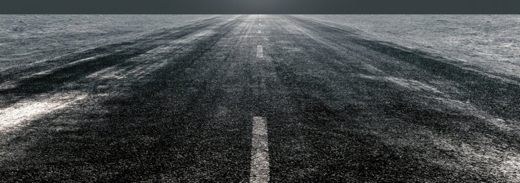 Perspective view of an empty asphalt road with a broken white line disappearing into the horizon