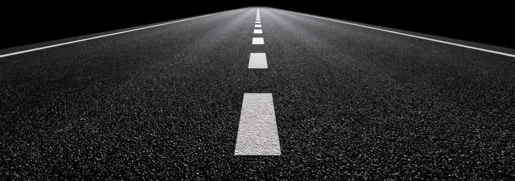 Asphalt highway vanishing into darkness with white lane markings