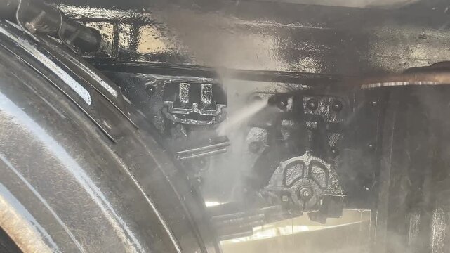 Clean truck chassis and mechanical components after washing, revealing polished metal surfaces prepared for inspection, maintenance, commercial transport service and industrial operation.