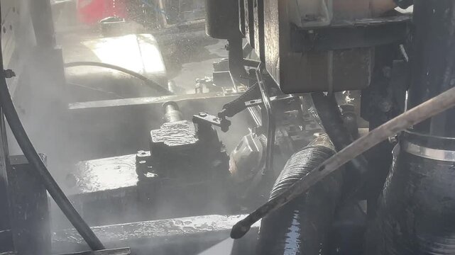 Clean truck engine compartment and chassis after professional washing, revealing polished mechanical components ready for inspection, maintenance and reliable commercial transport service.