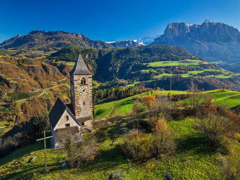 Aerial view of St Verena church in the Dolomites during autumn